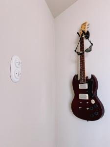 a guitar is hanging on a wall at Time Travel in Saint-Rambert-sur-Loire +9 photos
