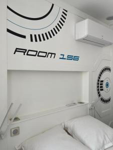 a bedroom with a bed and a sign on the wall at Time Travel in Saint-Rambert-sur-Loire