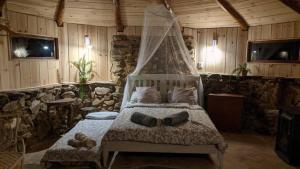 a bedroom with a bed with a mosquito net at Eco Roundhouse Quinta Carapeto in São Luis
