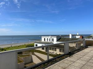 a view of the beach from the balcony of a house at Kalfamer Kalfamer 43 in Norderney
