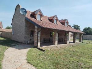 a brick building with a roof with a picnic table at Tamiški Mir in Staji°evo +21 photos