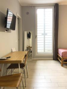 a living room with a table and a window at Sunny Beach Bari in Bari