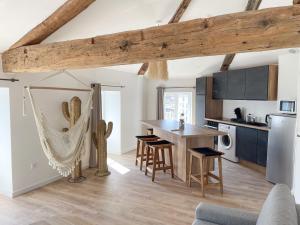 a kitchen and dining room with a table and chairs at La Casa in Montbrison