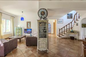 a living room with a clock on top of a clock tower at Villa Lefka Stunning Seaside Villa in Corfu with Private Gardens in Melíkia