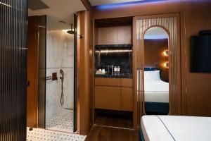 a bathroom with a shower and a bed in a room at Sura Concept Hotel in Istanbul