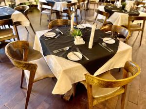 a dining table with a black table cloth and wooden chairs at The Sojourner By Genesis in Ikeja