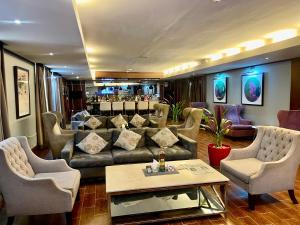 a living room with a couch and chairs at The Sojourner By Genesis in Ikeja