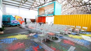 a room with a bunch of tables and chairs in it at WOT Peniche Social in Peniche