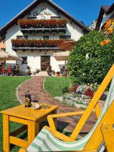 a chair and a table in front of a building at Casa Mia in Moieciu de Sus