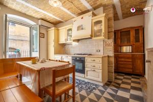 a kitchen with a table and a stove top oven at Casa Nel Borgo - WelcHome in Lanciano