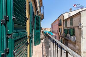 an alley with green shutters on a building at Casa Nel Borgo - WelcHome in Lanciano +8 photos