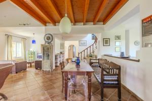 a dining room and living room with a table and chairs at Villa Lefka Stunning Seaside Villa in Corfu with Private Gardens in Melíkia