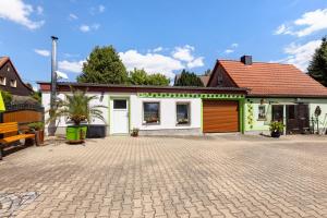 a house with a brick driveway in front of it at Ferienwohnung im Burgenland in Schleberoda