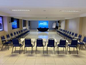 a conference room with chairs and a table and a podium at Hotel Asa Branca in Belo Jardim +104 photos