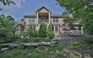 a large house with a landscaping in front of it at Poconos Playtime Paradise Luxury Play Escape in Pocono Pines