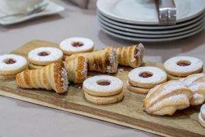 a tray of donuts and pastries on a table at HOTEL GAVINA EXPRESS IQUIQUE in Iquique