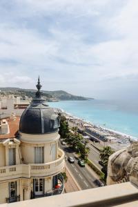a building with a dome on top of it next to the ocean at Hyatt Regency Nice Palais de la Méditerranée in Nice