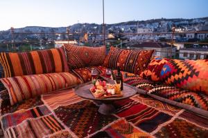a couch with a table on top of a balcony at Ayaz Stone House in Göreme