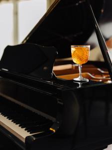 a glass of wine sitting on top of a piano at Hyatt Regency Nice Palais de la Méditerranée in Nice