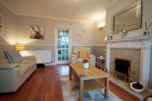 a living room with a couch and a fireplace at Potter's House Coventry in Foleshill