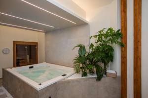 einen Whirlpool in einem Zimmer mit einer Pflanze in der Unterkunft White Corner in Thessaloniki
