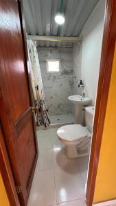 a bathroom with a toilet and a sink at Casa campestre con vista a Cáqueza in Cáqueza