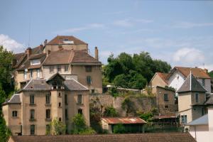 an old castle on top of a hill with houses at Gîte de la Beauze 2 in Aubusson
