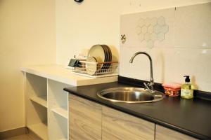 a kitchen with a sink and a counter at Evo Soho Bangi by Renjana Homestay in Bandar Baru Bangi
