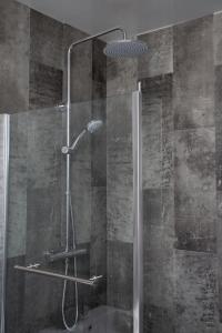 a shower in a bathroom with a glass door at The Burnopfield in Burnopfield
