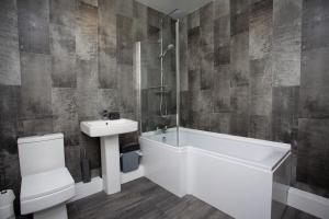 a bathroom with a sink and a tub and a toilet at The Burnopfield in Burnopfield +22 photos