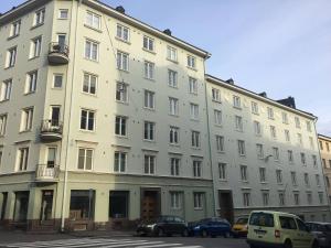 a large building with cars parked in front of it at Smart 32m2 studio in a central location - Kallio in Helsinki