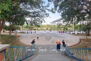 a group of people walking down stairs in a park at Evo Soho Bangi by Renjana Homestay in Bandar Baru Bangi