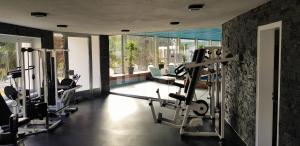a gym with tread machines in a room with windows at Davos - Cozy Escape - Mountain Rentals in Davos