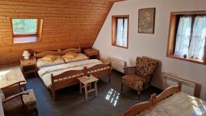a bedroom with two beds and a table and chairs at Penzion a restaurant Sportturia in Polesí