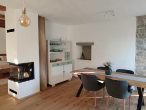 a kitchen and dining room with a table and chairs at Country house in Marezige