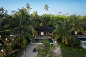 an aerial view of a resort with a pool and palm trees at The Residence Zanzibar in Kizimkazi