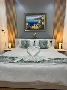 a bedroom with a bed with a heart on it at 65 Pradit in Nai Yang Beach