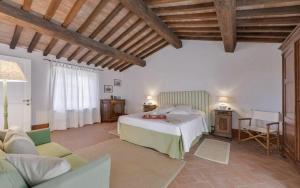 a large bedroom with a bed and a couch at Villa Lotus Magliano in Magliano in Toscana +32 photos