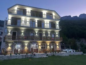 a large building with lights on top of it at Hotel Vellezrit Guri in Theth