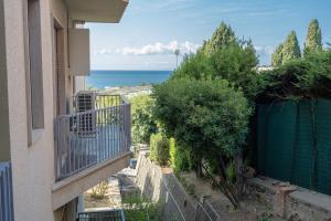 a balcony of a building with a view of the ocean at E&J Mare e Relax in Sanremo