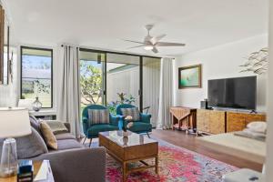 a living room with a couch and a tv at Pulelehua Kuilima Estates West #142 in Kahuku
