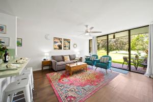 a living room with a couch and a table at Pulelehua Kuilima Estates West #142 in Kahuku