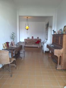 a living room with a piano and a couch at Casa Por do Sol in Rio de Janeiro +20 photos