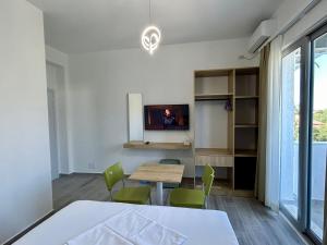 een kamer met een tafel en een tv aan de muur bij River Residence in Orikum +37 foto's