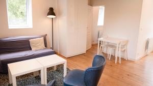 a living room with a bed and a table and chairs at Manoir des Carreaux in Ingouville