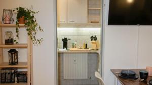a kitchen with white cabinets and a counter top at Ferienwohnung mit Bergblick & Netflix in Oberammergau
