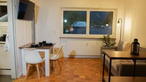 a small living room with a table and a window at Ferienwohnung mit Bergblick & Netflix in Oberammergau