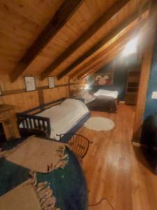 a attic room with a bed and a couch at Na'raucária in Cambará