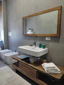 a bathroom with a sink and a toilet and a mirror at Casa alloggio Aprìco - abitare il relax in città in Potenza +55 photos