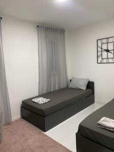 a small bedroom with a bed in a room at Villa La Familia in Bihać